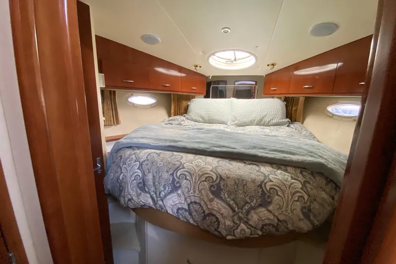 Slippin Out Yacht Photos Pics Luxurious bedroom interior of 2004 Carver 36 Super Sport yacht with elegant bedding.