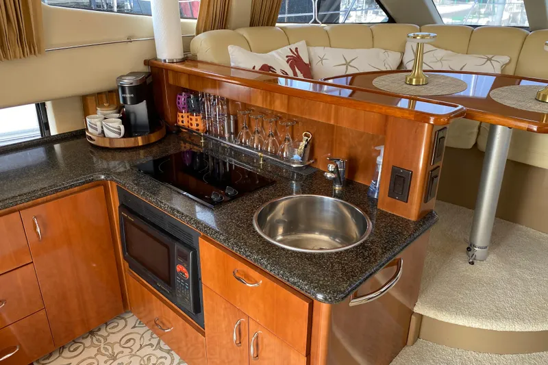 Slippin Out Yacht Photos Pics Luxurious 2004 Carver 36 Super Sport yacht interior with kitchenette and seating area.