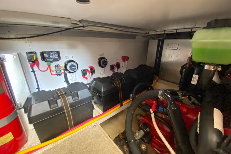 Slippin Out Yacht Photos Pics Engine room of a 2004 Carver 36 Super Sport, featuring batteries and control systems.