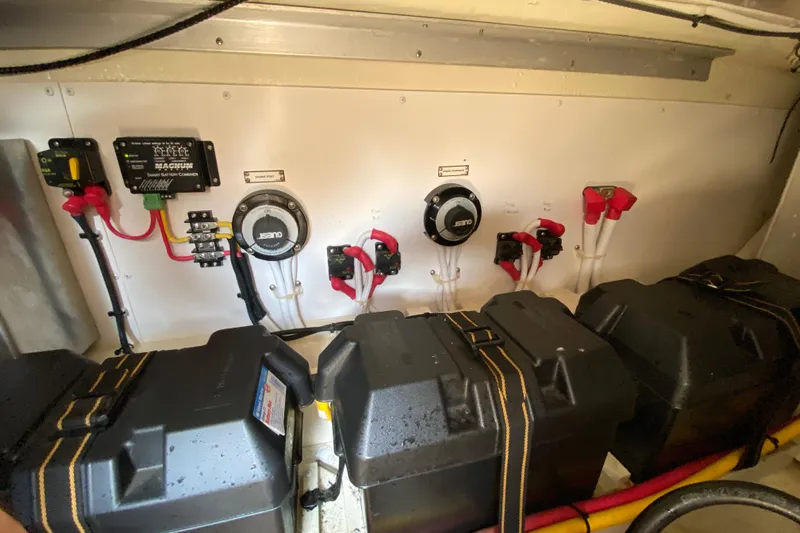 Slippin Out Yacht Photos Pics Electrical system of a 2004 Carver 36 Super Sport boat, featuring battery chargers and connections.