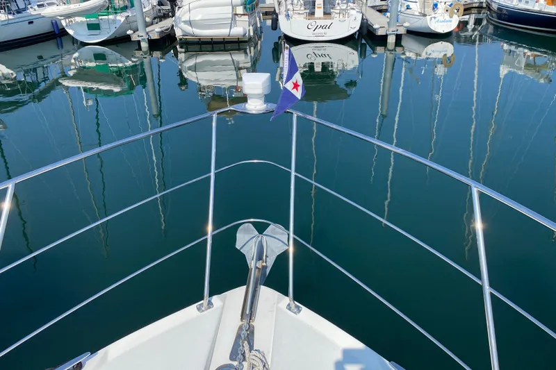 Slippin Out Yacht Photos Pics Bow view of 2004 Carver 36 Super Sport yacht in marina, calm water reflections.