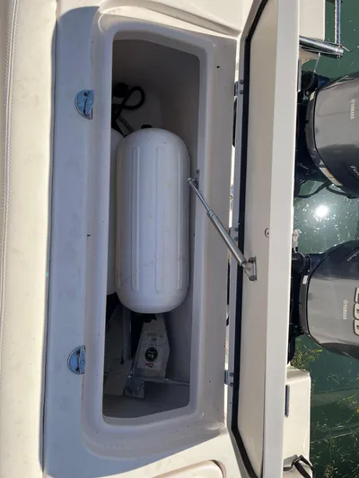  Yacht Photos Pics Open storage compartment on 2023 Grady-White Freedom 275 boat, showing equipment and dual engines.