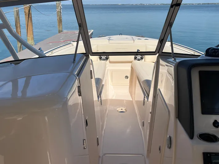 Yacht Photos Pics 2023 Grady-White Freedom 275 boat interior with open deck and water view.