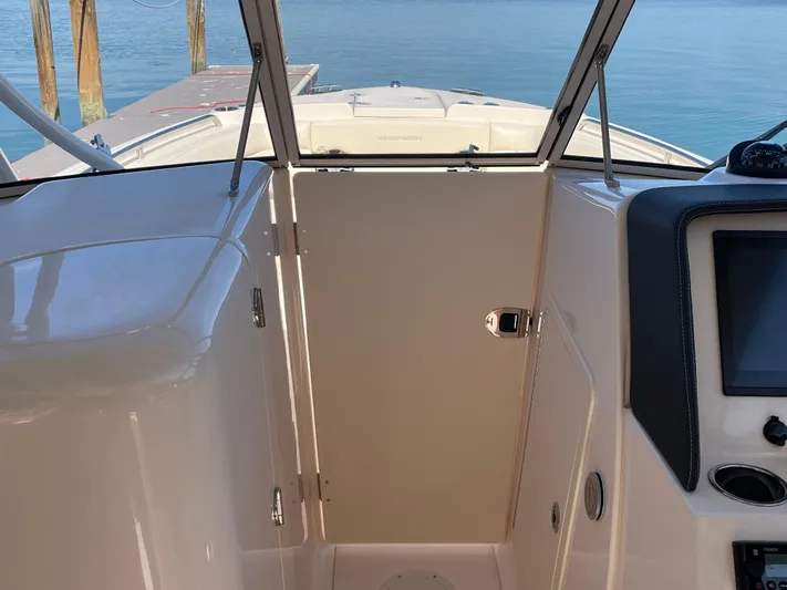  Yacht Photos Pics 2023 Grady-White Freedom 275 boat interior with dashboard and open water view.