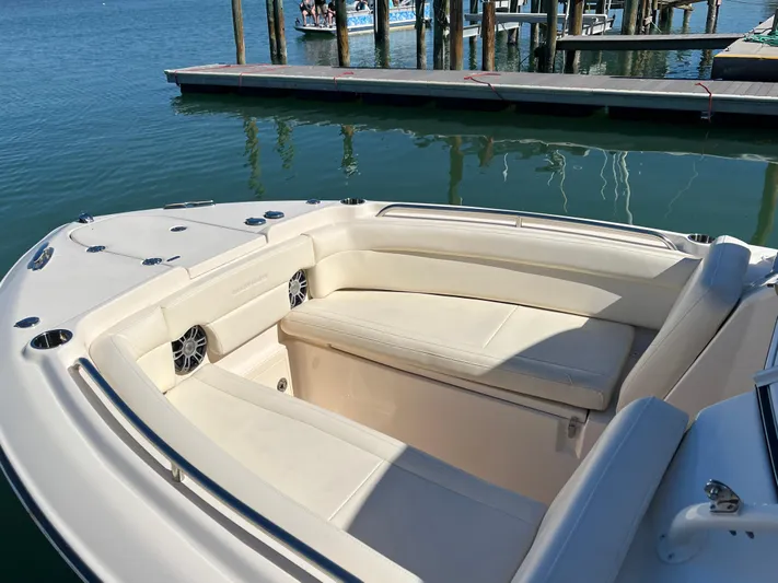  Yacht Photos Pics 2023 Grady-White Freedom 275 boat interior with seating at a marina dock.