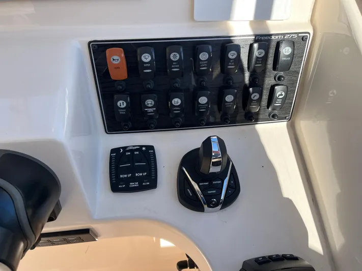  Yacht Photos Pics Control panel of 2023 Grady-White Freedom 275 boat with various switches and joystick.
