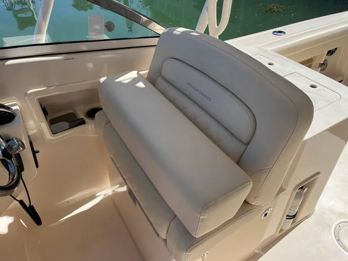  Yacht Photos Pics 2023 Grady-White Freedom 275 boat interior with beige seating and control panel.