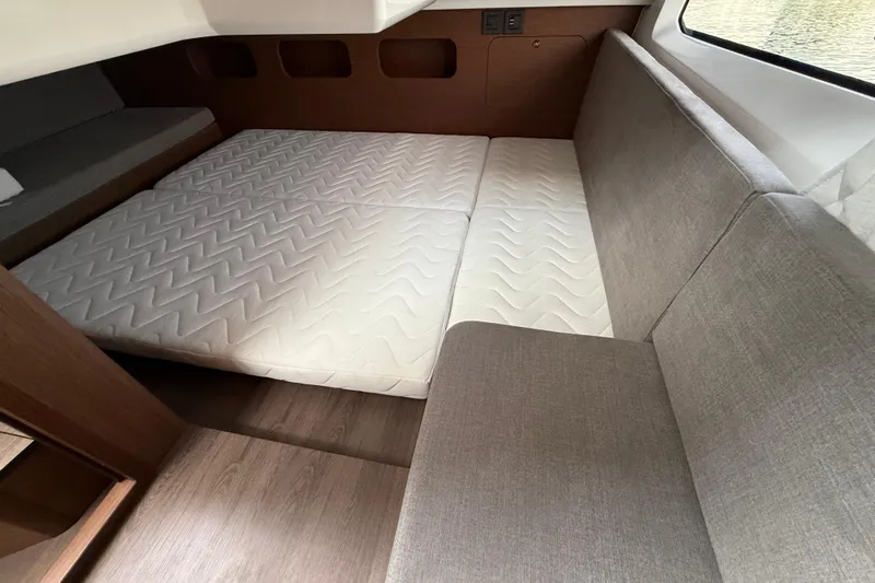  Yacht Photos Pics Interior cabin of 2026 Beneteau Antares 11 Fly with cozy mattress and seating.