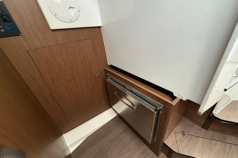  Yacht Photos Pics 2026 Beneteau Antares 11 Fly interior with wood paneling and built-in storage.