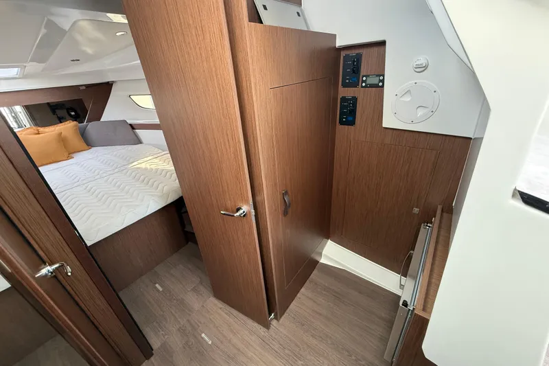  Yacht Photos Pics 2026 Beneteau Antares 11 Fly cabin interior with wood finish and cozy bed.
