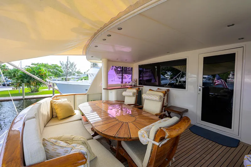 Forever Young Yacht Photos Pics Luxurious 1991 Hatteras 78 CMY yacht deck with elegant seating and dining area.