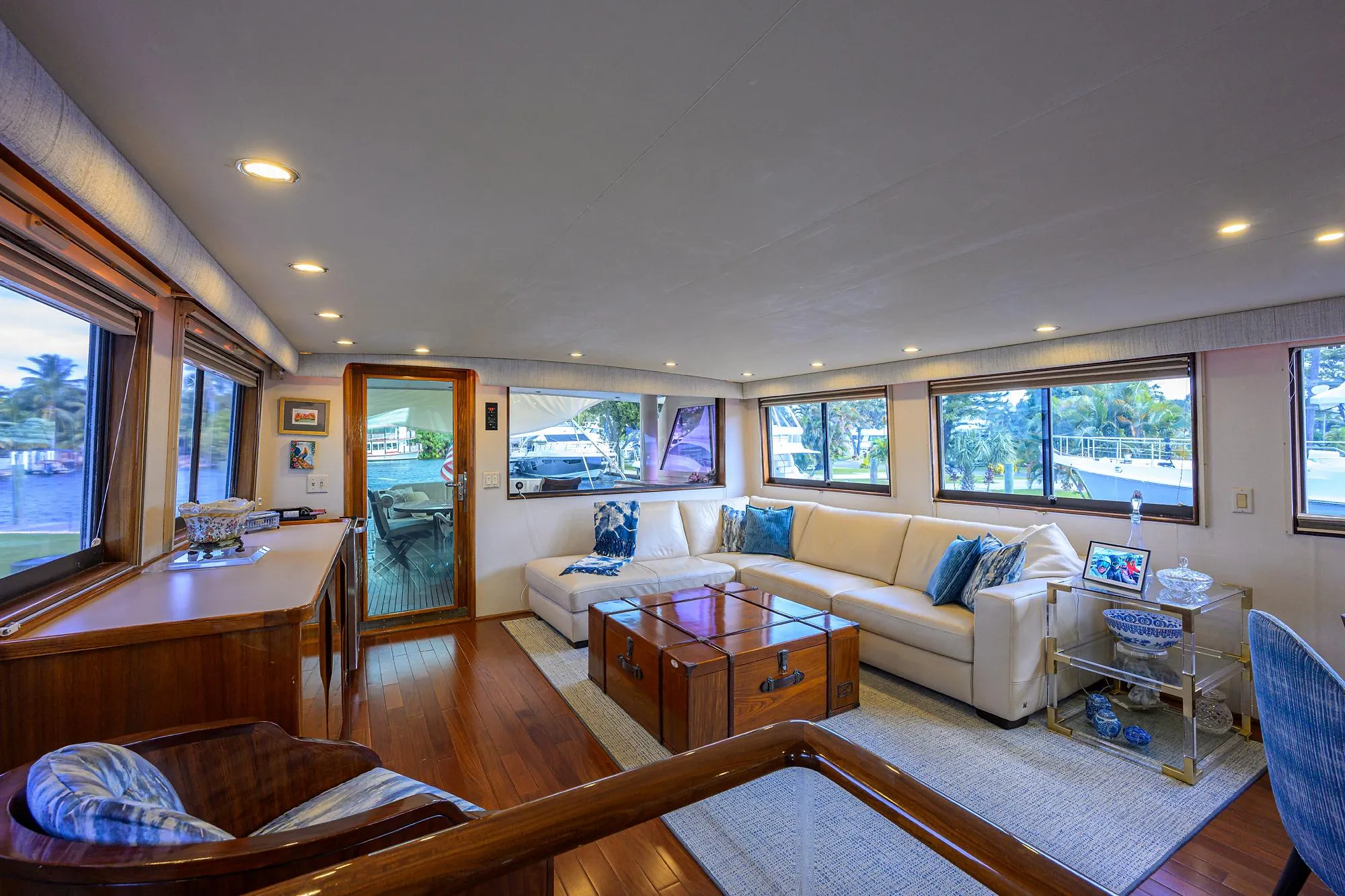 Luxurious interior of 1991 Hatteras 78 CMY yacht with elegant seating and large windows.