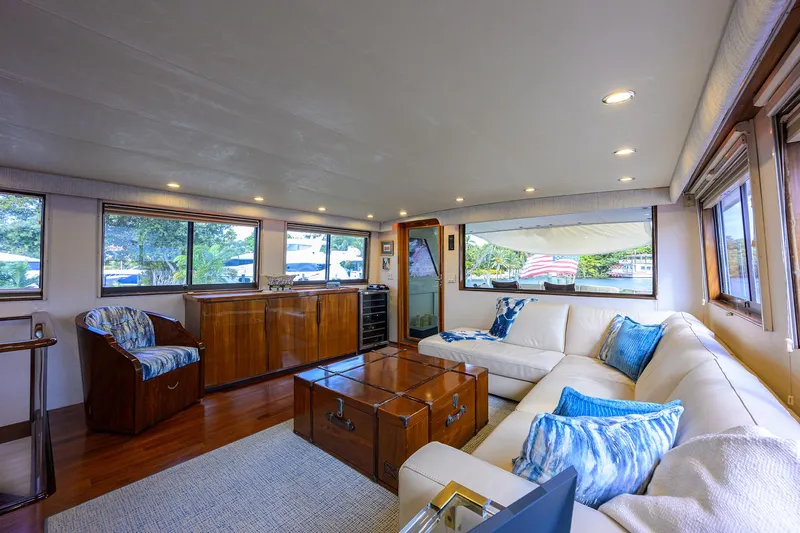 Forever Young Yacht Photos Pics Luxurious interior of 1991 Hatteras 78 CMY yacht with elegant seating and wooden accents.