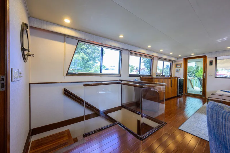 Forever Young Yacht Photos Pics Interior of 1991 Hatteras 78 CMY yacht with wooden flooring and large windows.