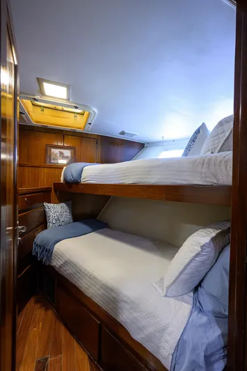Forever Young Yacht Photos Pics Cozy bunk beds in 1991 Hatteras 78 CMY yacht cabin with wooden interior.