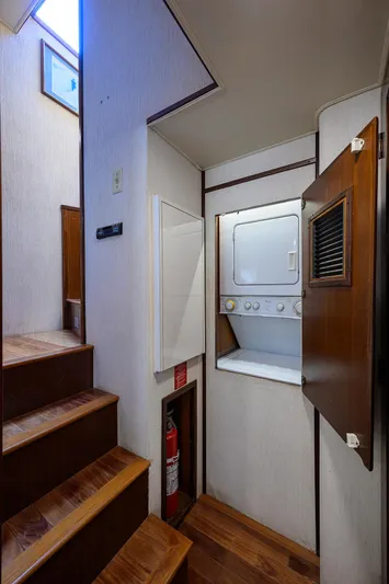Forever Young Yacht Photos Pics Laundry area on 1991 Hatteras 78 CMY yacht with stacked washer and dryer.
