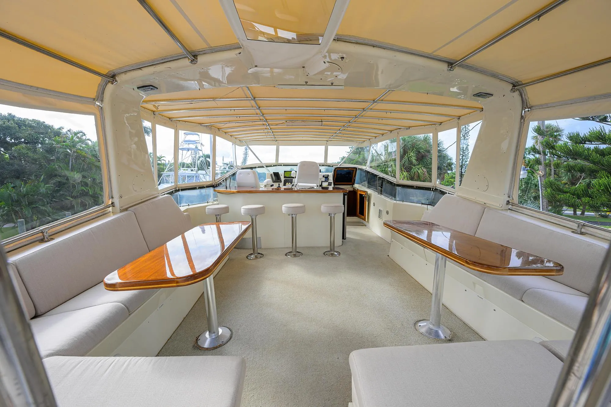 Spacious interior of 1991 Hatteras 78 CMY yacht with elegant seating and tables.