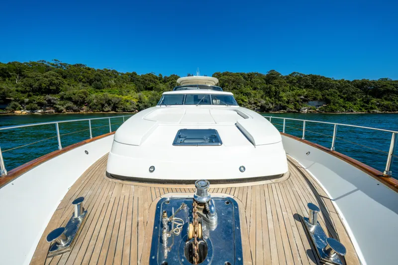 Ilyria Yacht Photos Pics 2007 Sanlorenzo SL72 yacht on water, featuring sleek deck and lush shoreline backdrop.