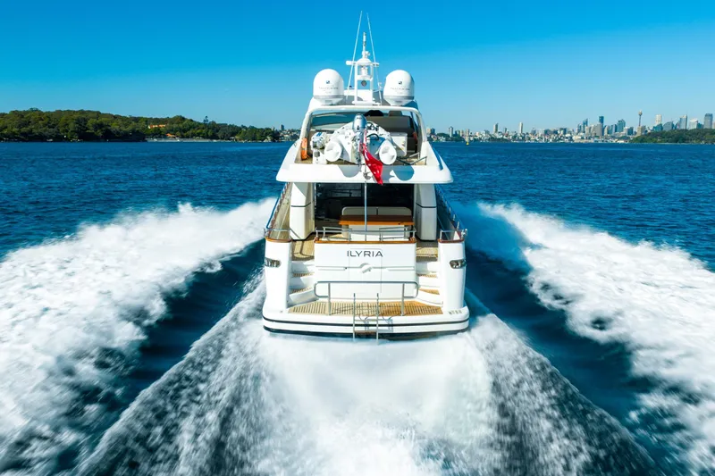 Ilyria Yacht Photos Pics 2007 Sanlorenzo SL72 yacht cruising on open water with city skyline in background.