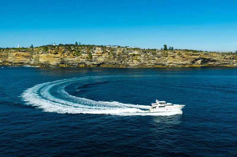 Ilyria Yacht Photos Pics Sanlorenzo SL72 yacht cruising near rocky coastline, 2007 model.