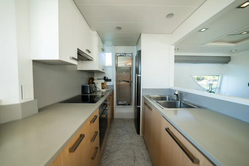 Ilyria Yacht Photos Pics Modern kitchen interior of 2007 Sanlorenzo SL72 yacht, featuring sleek countertops and stainless steel appliances.