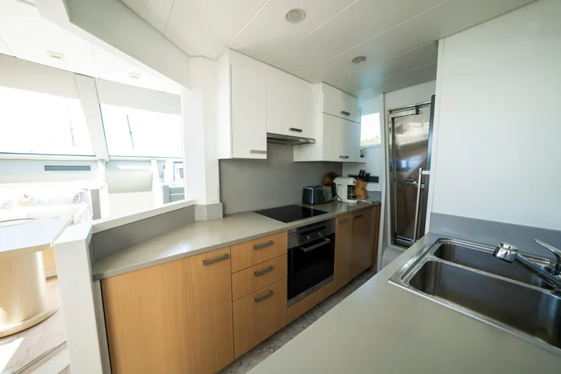 Ilyria Yacht Photos Pics Modern kitchen interior on a 2007 Sanlorenzo SL72 yacht, featuring sleek cabinetry and appliances.