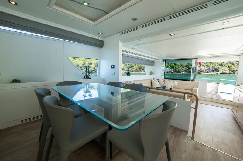 Ilyria Yacht Photos Pics Luxurious interior of 2007 Sanlorenzo SL72 yacht with glass dining table and scenic views.