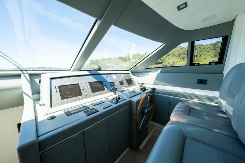 Ilyria Yacht Photos Pics Helm of 2007 Sanlorenzo SL72 yacht with modern navigation equipment and leather seating.