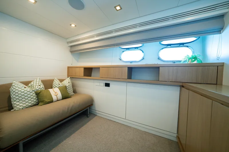 Ilyria Yacht Photos Pics Luxurious interior of 2007 Sanlorenzo SL72 yacht with modern furnishings and porthole windows.