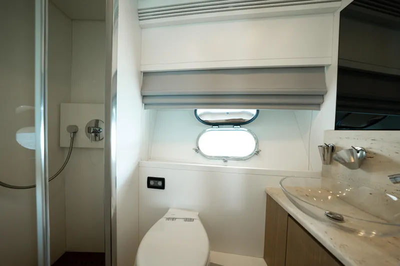Ilyria Yacht Photos Pics Luxurious bathroom in 2007 Sanlorenzo SL72 yacht with modern fixtures and porthole window.