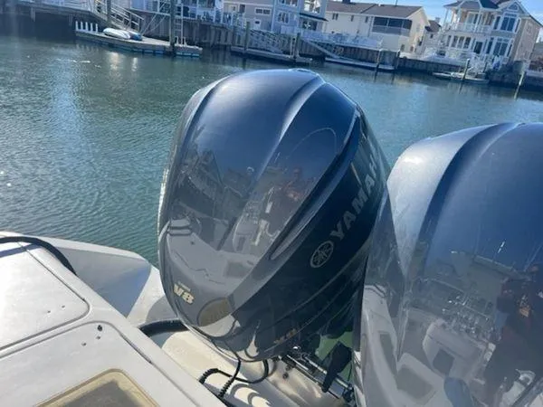  Yacht Photos Pics Twin Yamaha outboard motors on a 2008 Spectre 34 boat, docked in a marina.