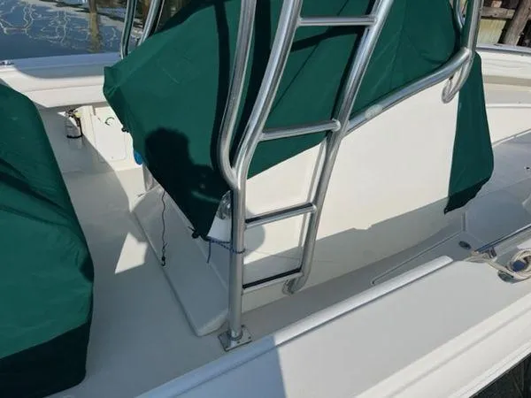  Yacht Photos Pics 2008 Spectre 34 boat with green covers and metal ladder on deck.