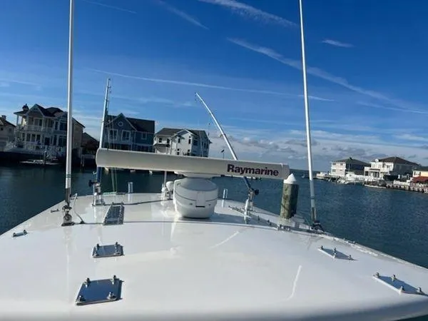  Yacht Photos Pics Bow view of 2008 Spectre 34 boat with Raymarine equipment, docked near waterfront homes.