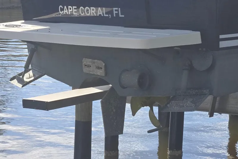 Bay'be Yacht Photos Pics 2009 Mainship Pilot 31 boat stern view, Cape Coral, FL, docked in water.