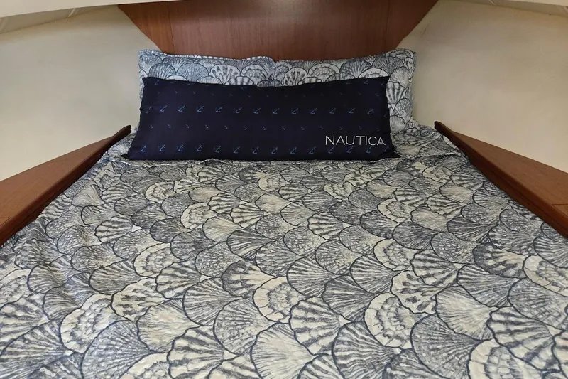 Bay'be Yacht Photos Pics Cozy cabin bed in 2009 Mainship Pilot 31 boat with patterned bedding and Nautica pillow.