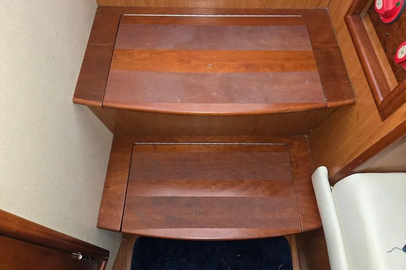 Bay'be Yacht Photos Pics Wooden steps inside a 2009 Mainship Pilot 31 boat, featuring polished finish.