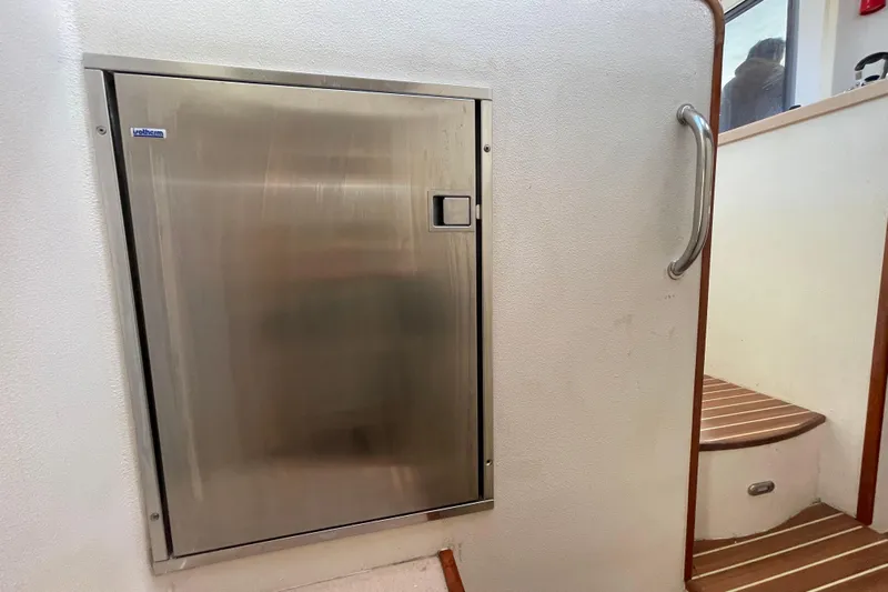 Nadi Yacht Photos Pics Stainless steel door on 2010 Knysna 480 yacht interior with wooden steps.