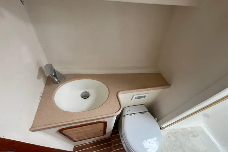 Nadi Yacht Photos Pics Compact bathroom in 2010 Knysna 480 yacht with sink and toilet.