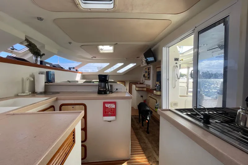 Nadi Yacht Photos Pics Interior of 2010 Knysna 480 yacht with kitchen, dog, and ocean view.