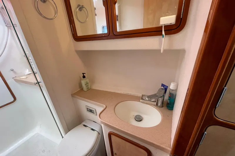 Nadi Yacht Photos Pics Compact bathroom in 2010 Knysna 480 yacht with sink, mirror, and shower.