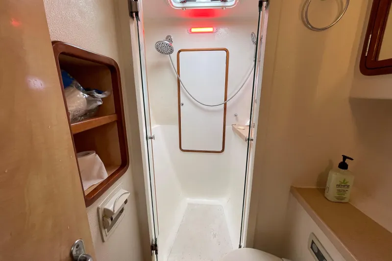 Nadi Yacht Photos Pics Compact bathroom in 2010 Knysna 480 yacht with shower and storage shelves.
