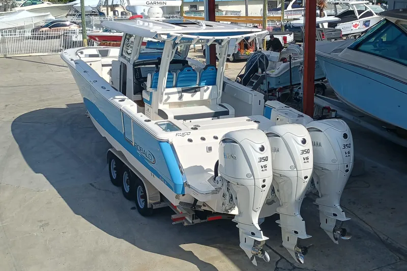360-105 Yacht Photos Pics 2026 Robalo R360 Center Console boat with triple Yamaha 350 engines in a marina.