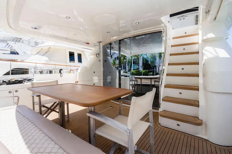 Voluptas Yacht Photos Pics Luxurious 2006 Aicon Flybridge yacht interior with elegant dining area and wooden staircase.