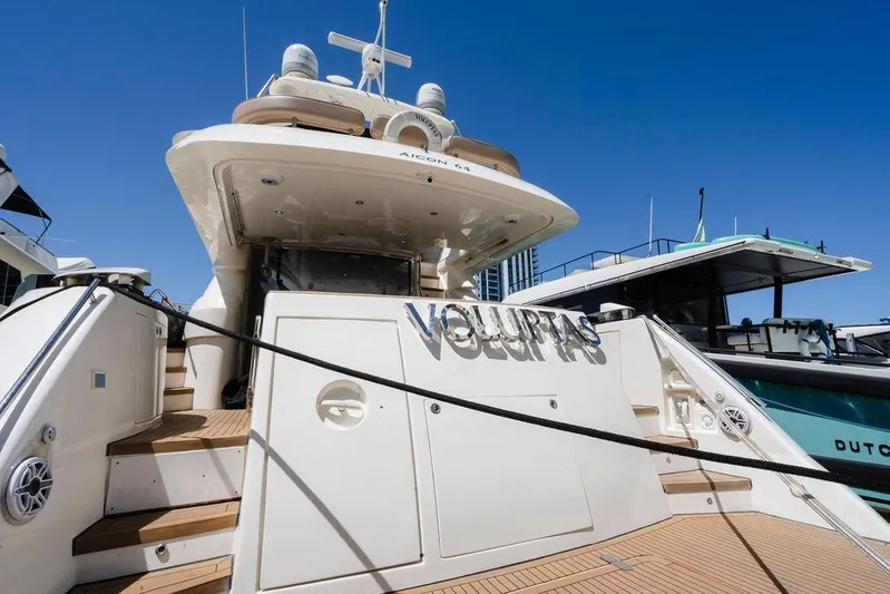 Voluptas Yacht Photos Pics Luxury 2006 Aicon Flybridge yacht docked under clear blue sky.