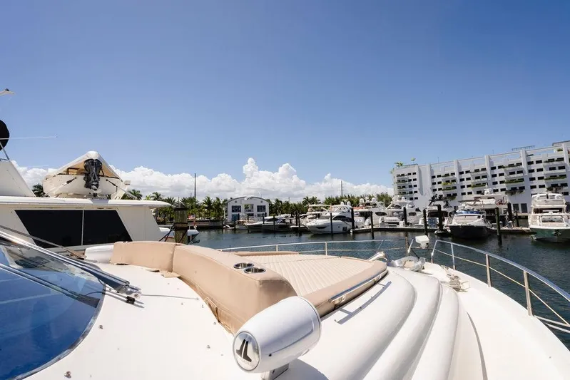 Voluptas Yacht Photos Pics 2006 Aicon Flybridge yacht docked at marina under clear blue sky.