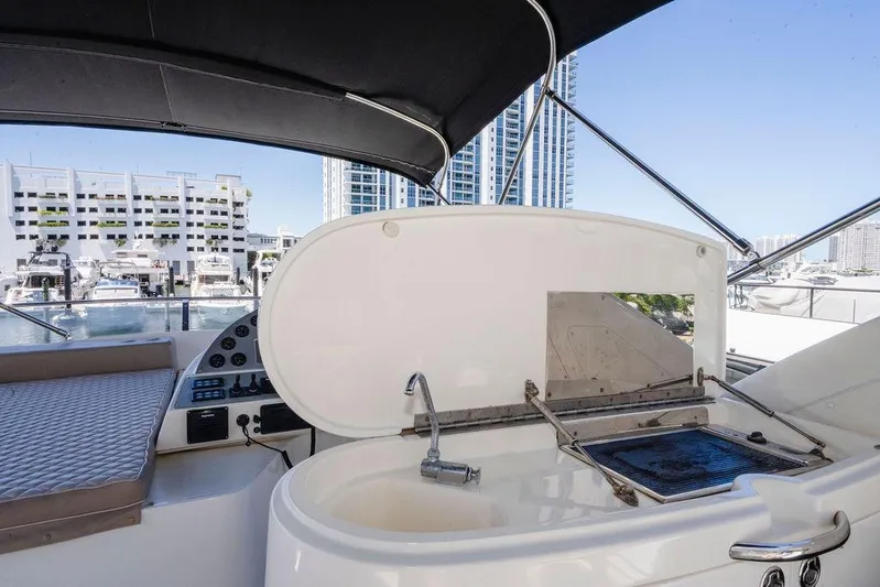 Voluptas Yacht Photos Pics Flybridge of 2006 Aicon yacht with grill and sink, overlooking marina and cityscape.