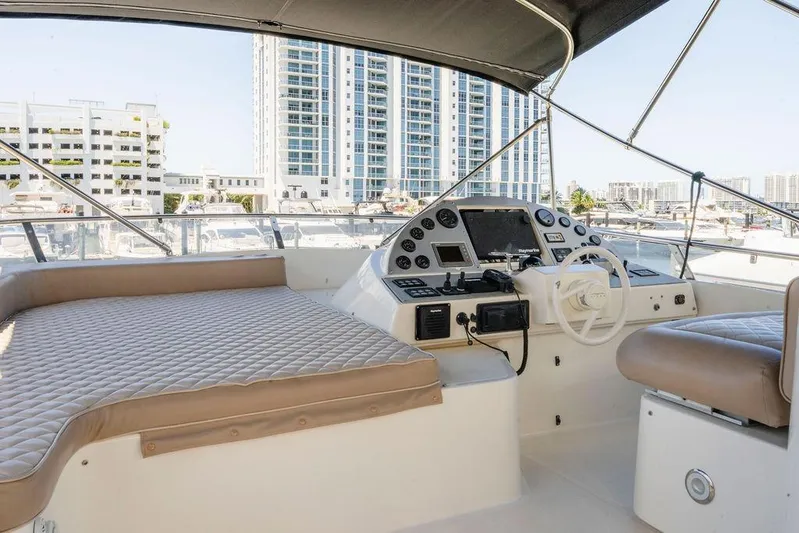 Voluptas Yacht Photos Pics Luxurious 2006 Aicon Flybridge yacht interior with modern helm and cityscape view.