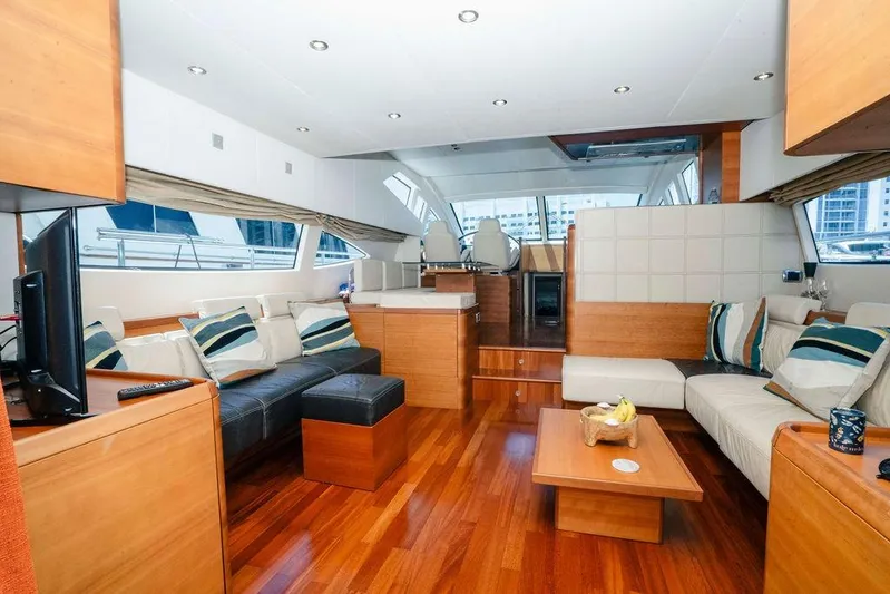 Voluptas Yacht Photos Pics Luxurious interior of a 2006 Aicon Flybridge yacht with modern furnishings and wooden flooring.