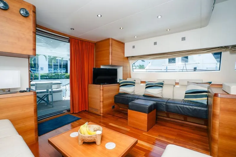 Voluptas Yacht Photos Pics Luxurious 2006 Aicon Flybridge yacht interior with modern wood finishes and comfortable seating.