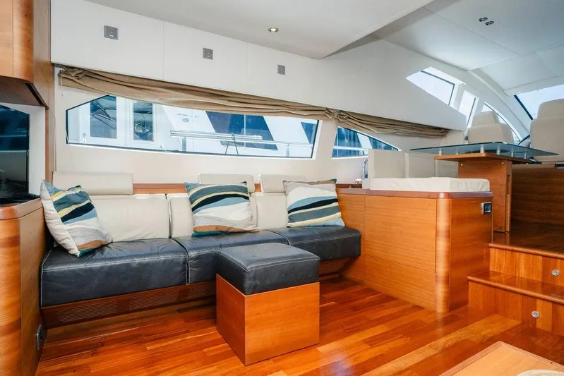 Voluptas Yacht Photos Pics Luxurious 2006 Aicon Flybridge yacht interior with modern seating and elegant wood finishes.